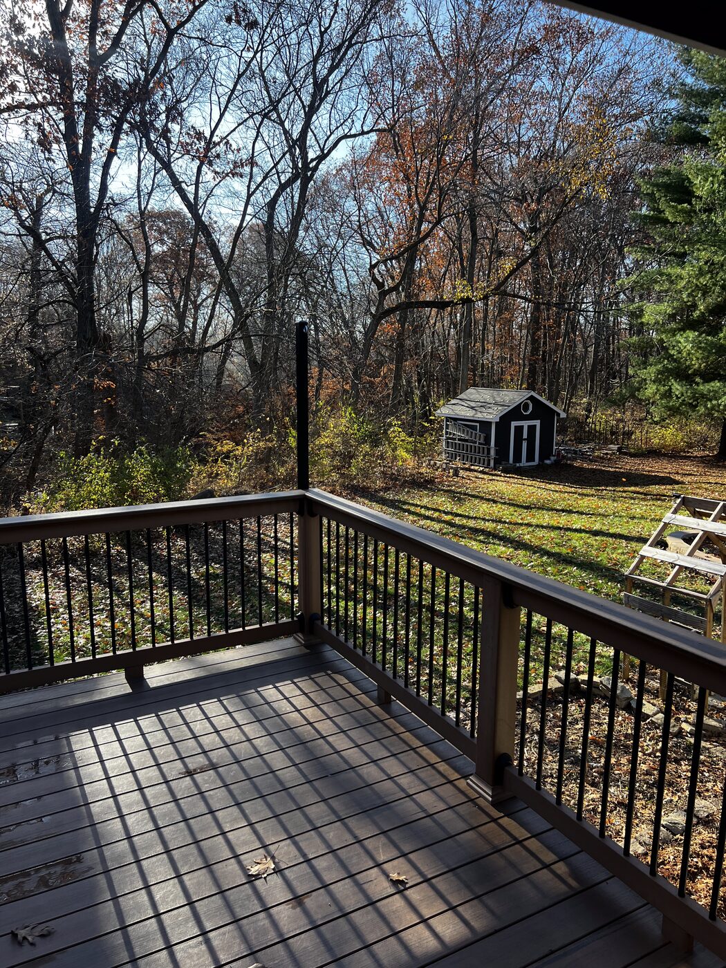 A backyard deck overlooking wooded space behind a Des Moines-area home.